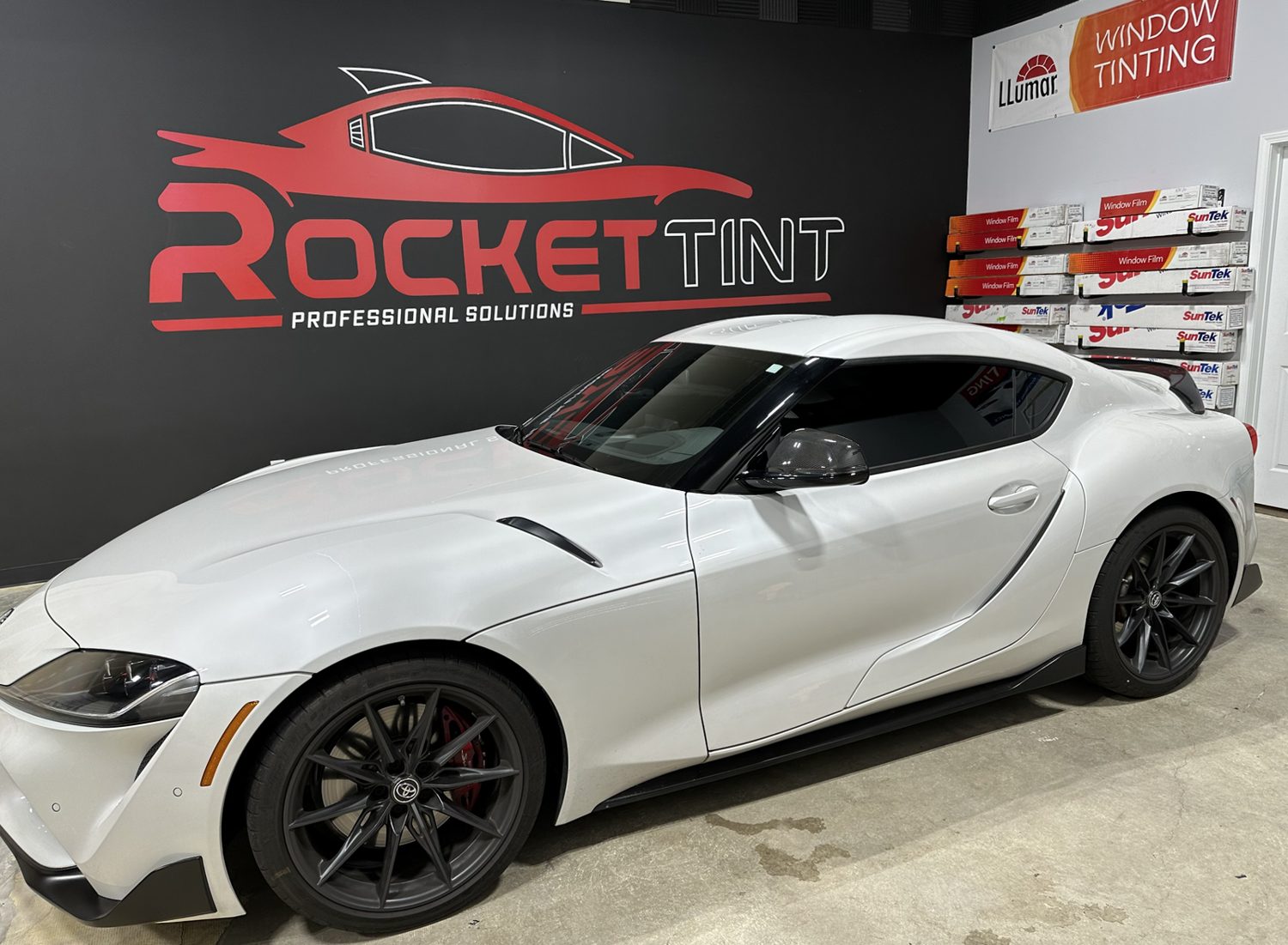 Freshly tinted Toyota Supra inside the Rocket Tint shop bay